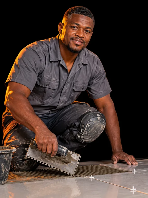 Tiler laying large-format floor tiles in South Africa – web design for tiling companies